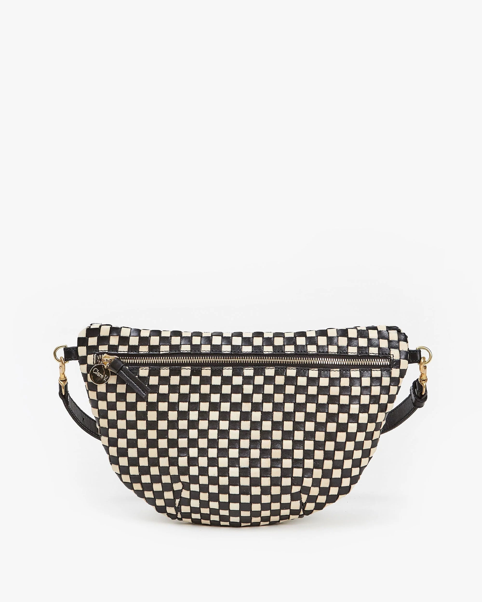 The Grande Fanny S25 by Clare Vivier is a crescent-shaped crossbody bag in black and cream checkerboard handwoven leather, featuring a top zipper, adjustable strap with gold hardware, shown on a white background.