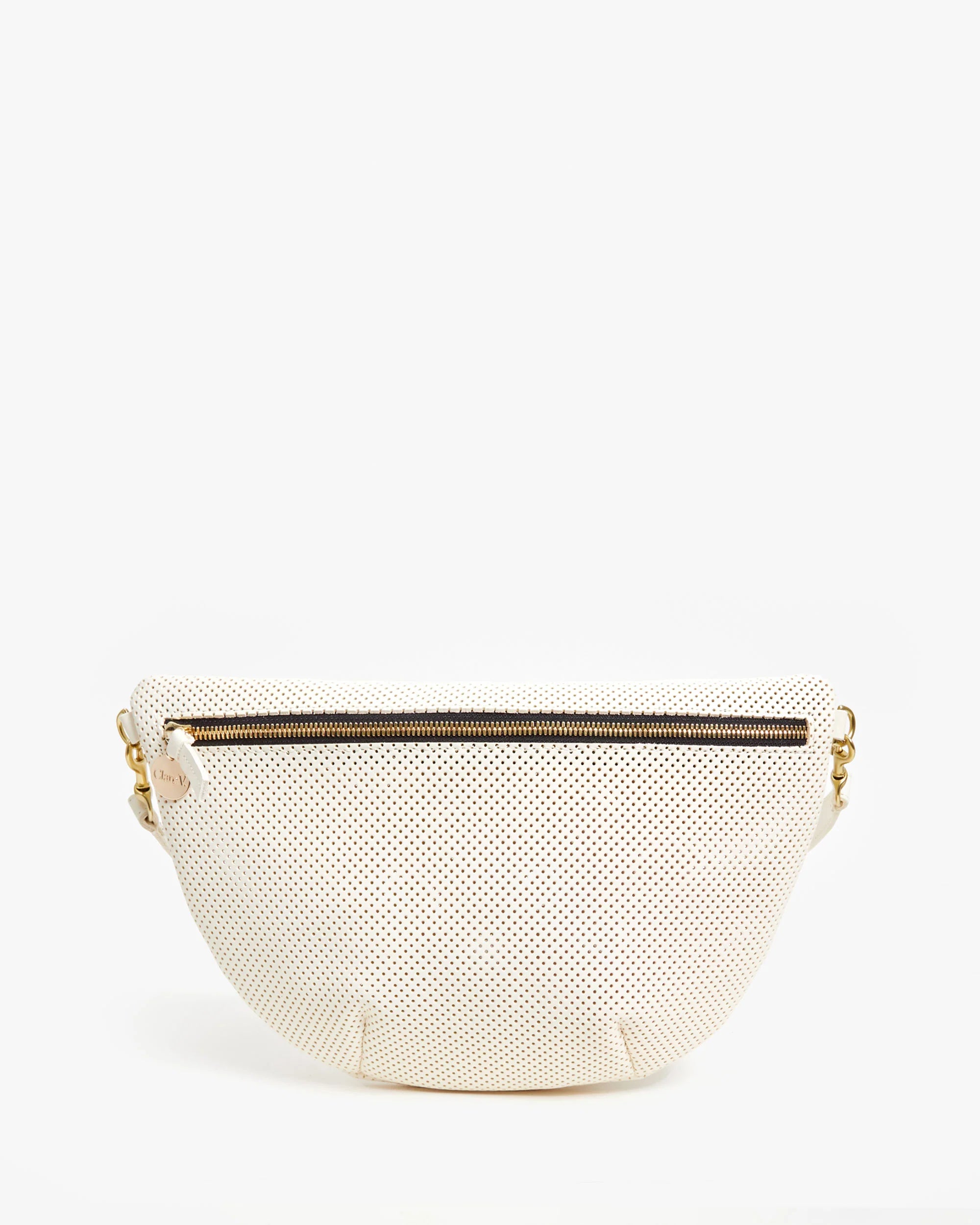 The Grande Fanny Perf by Clare Vivier is a white textured leather handbag with a curved bottom and top black zipper. This versatile piece can be worn as a crossbody, featuring a detachable strap with gold clasps on each side. The background is plain white.