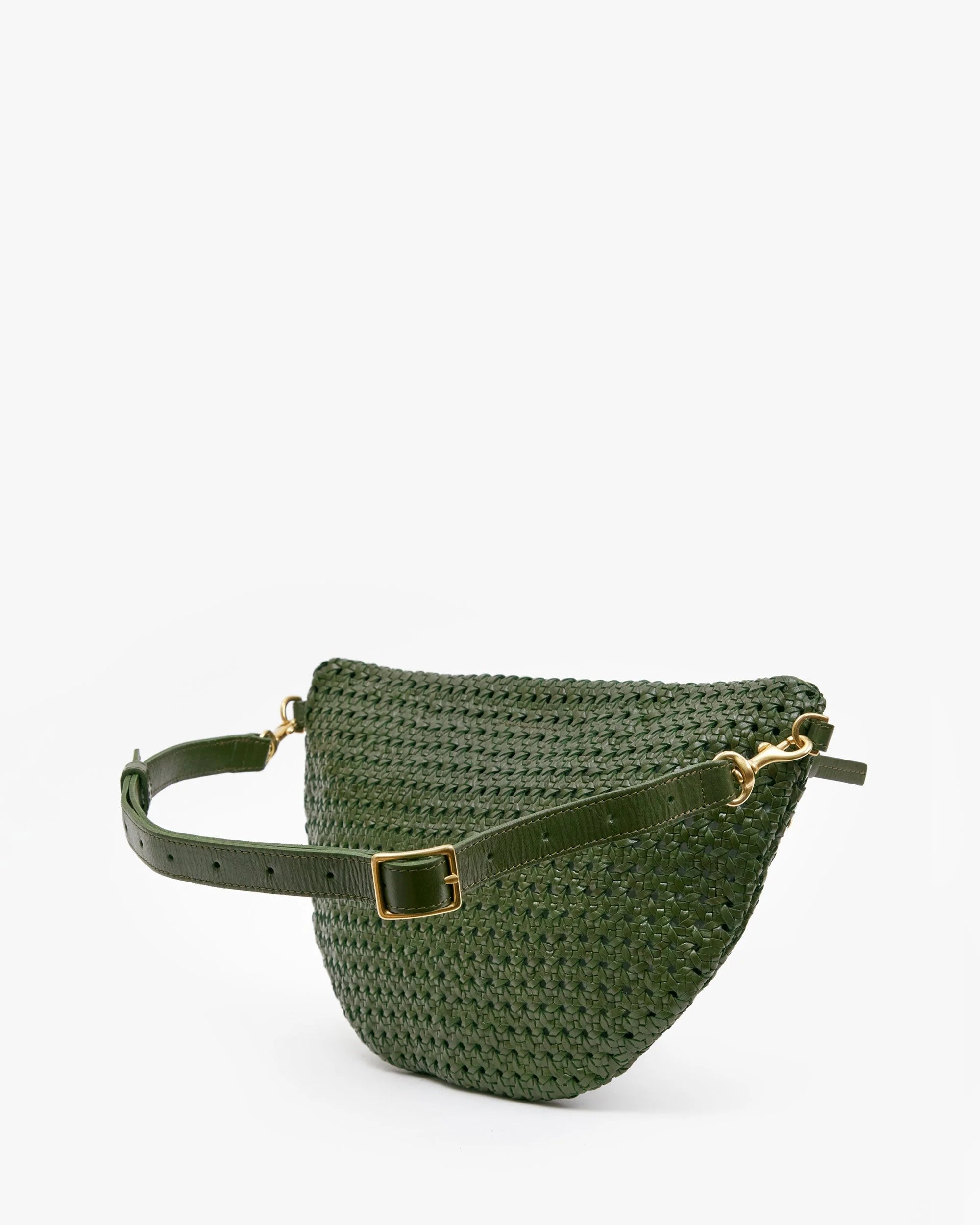 The Grande Fanny S25 by Clare Vivier is a dark green handwoven leather bag with a matching adjustable strap and gold buckle, shown on a plain white background.