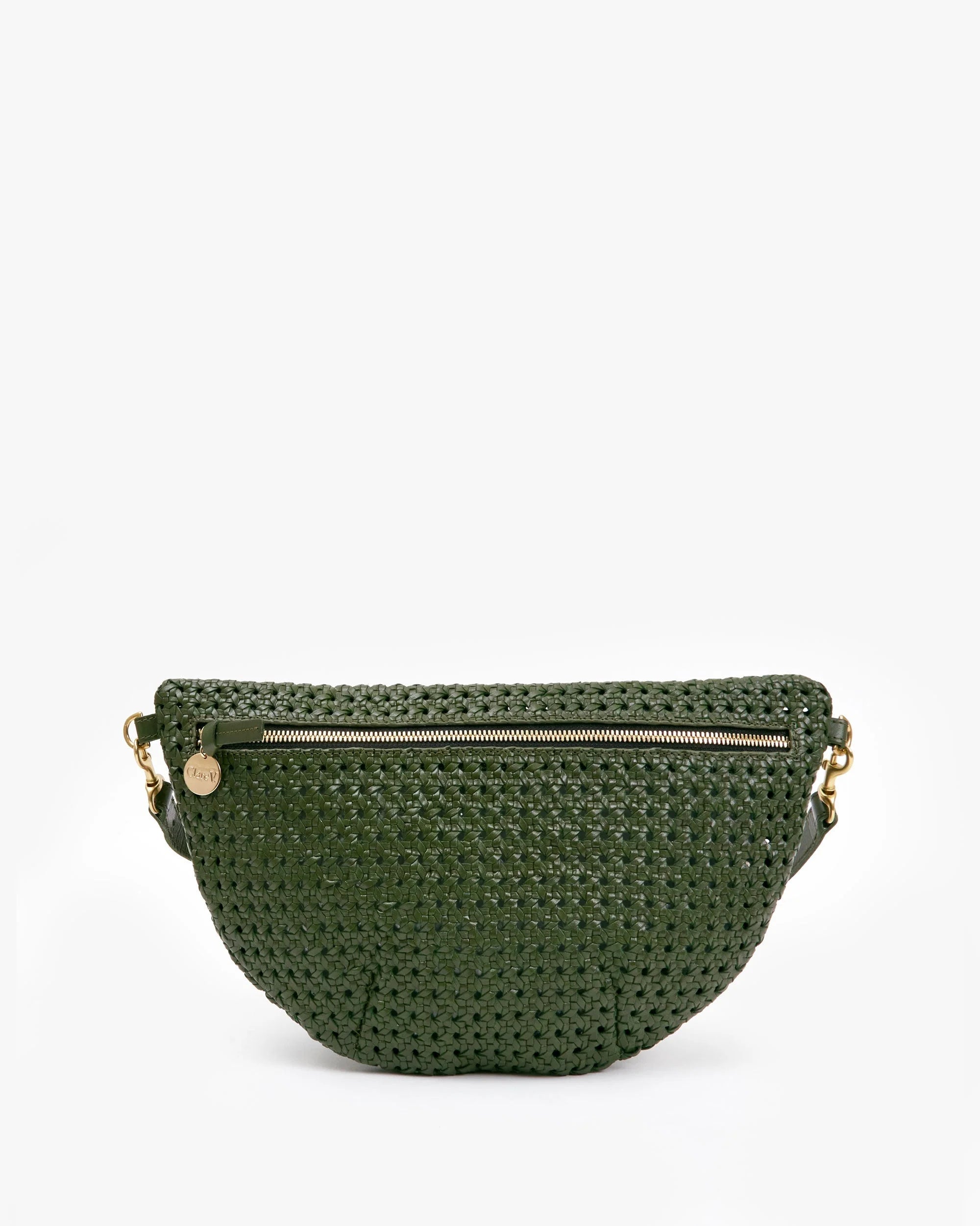 The Clare Vivier Grande Fanny S25, a dark green crossbody with a half-moon silhouette, showcases handwoven leather, a front zipper pocket, gold hardware, and a signature round gold charm against a white background.