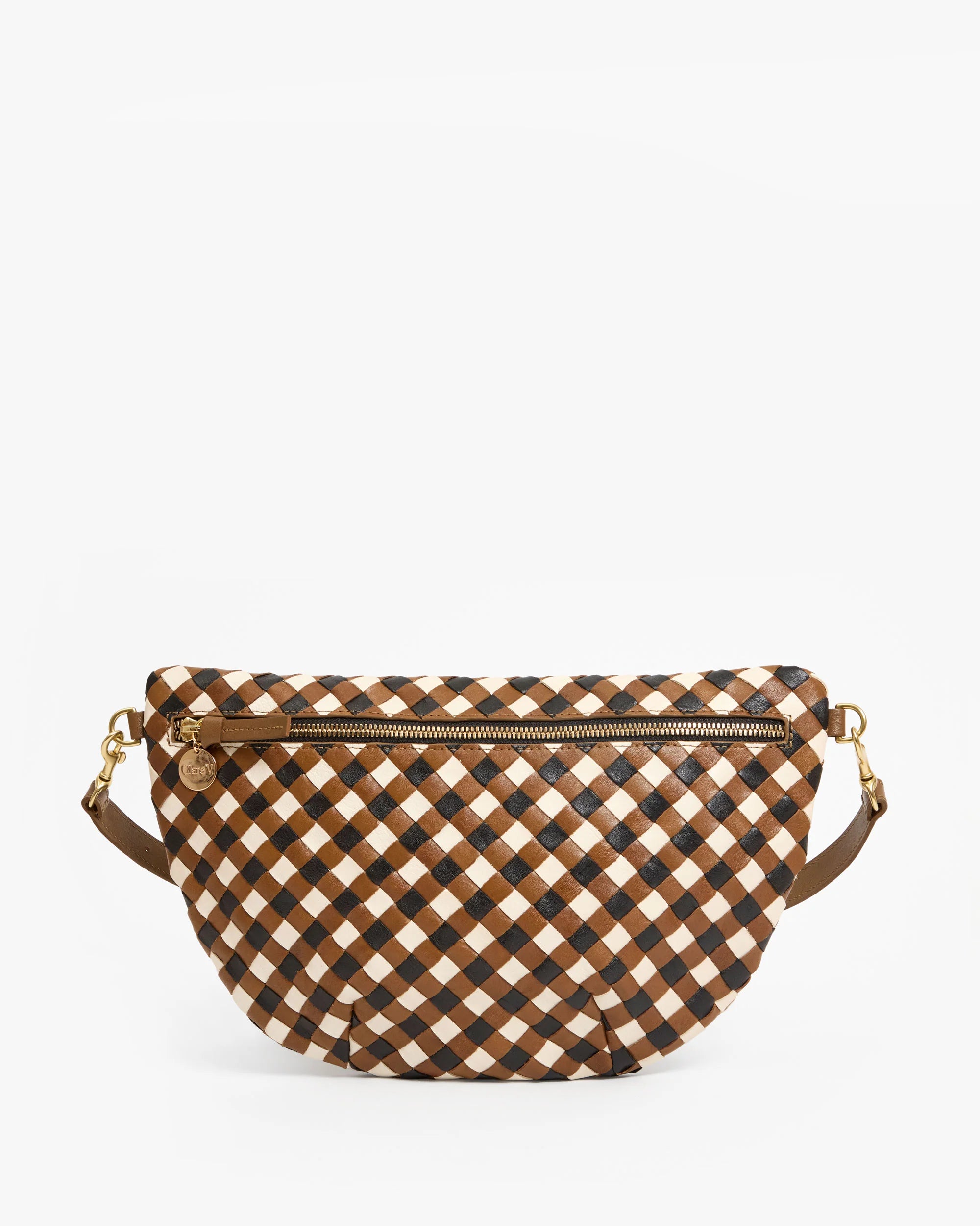 The Clare Vivier Grande Fanny S26 is a crescent-shaped handwoven leather bag with a brown, black, and white checkered pattern, gold front zipper, and brown strap with gold hardware. Shown on a plain white background.