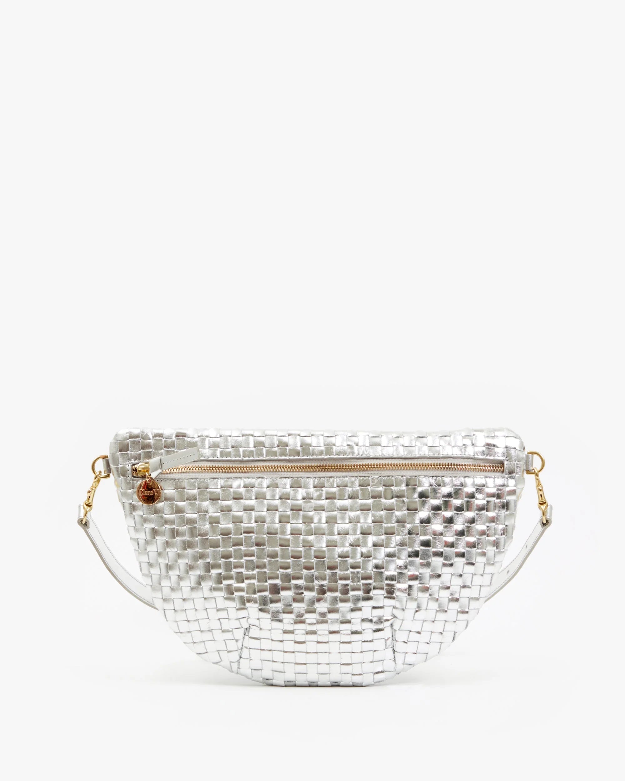 The Grande Fanny S25 by Clare Vivier is a metallic silver handwoven leather crossbody bag featuring a zipper closure, gold hardware, and a detachable adjustable strap, shown against a plain white background.