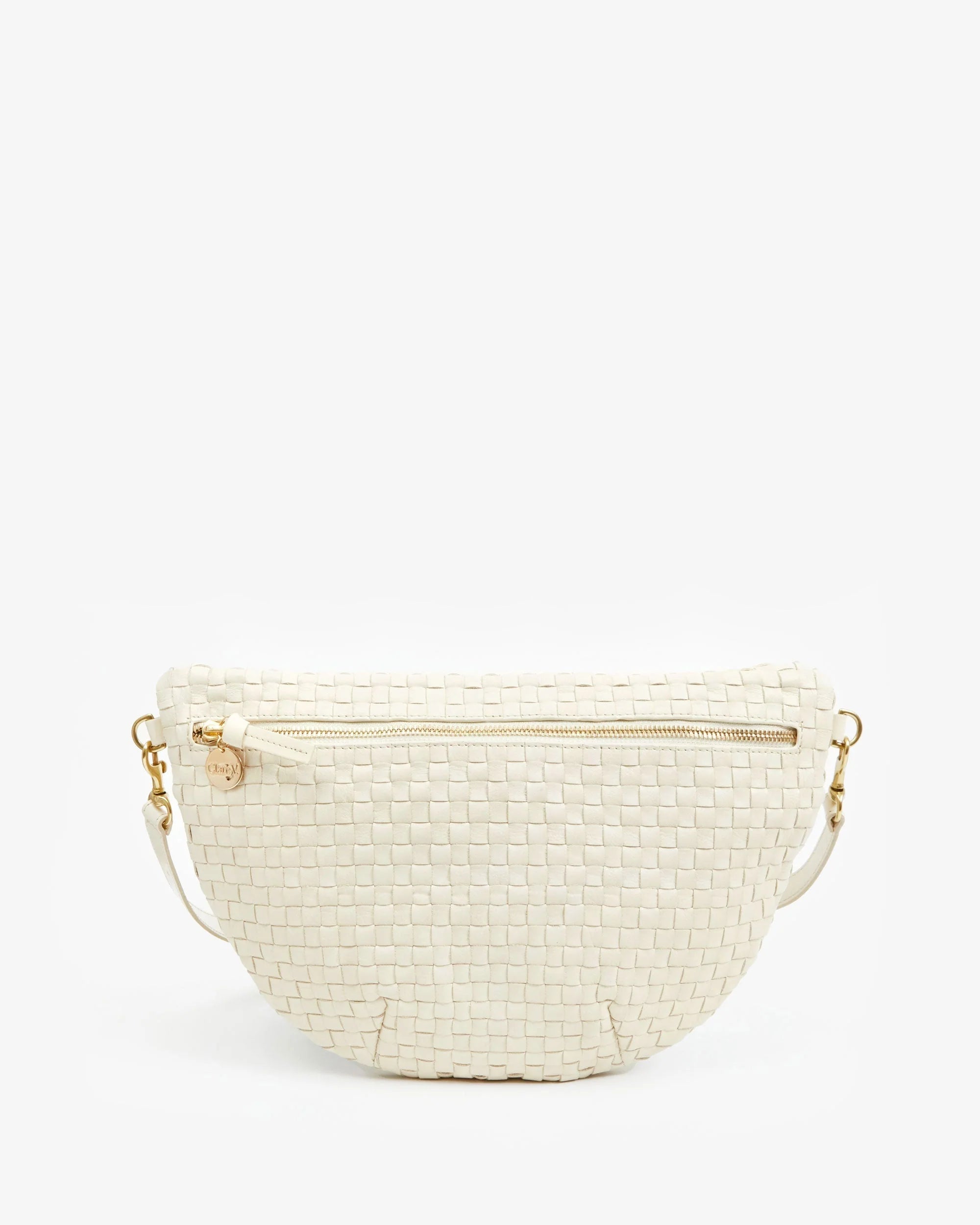 The Clare Vivier Grande Fanny S25 is a handwoven, cream leather belt bag with gold hardware, an adjustable strap, and a small round charm on the zipper pull, shown against a plain white background.