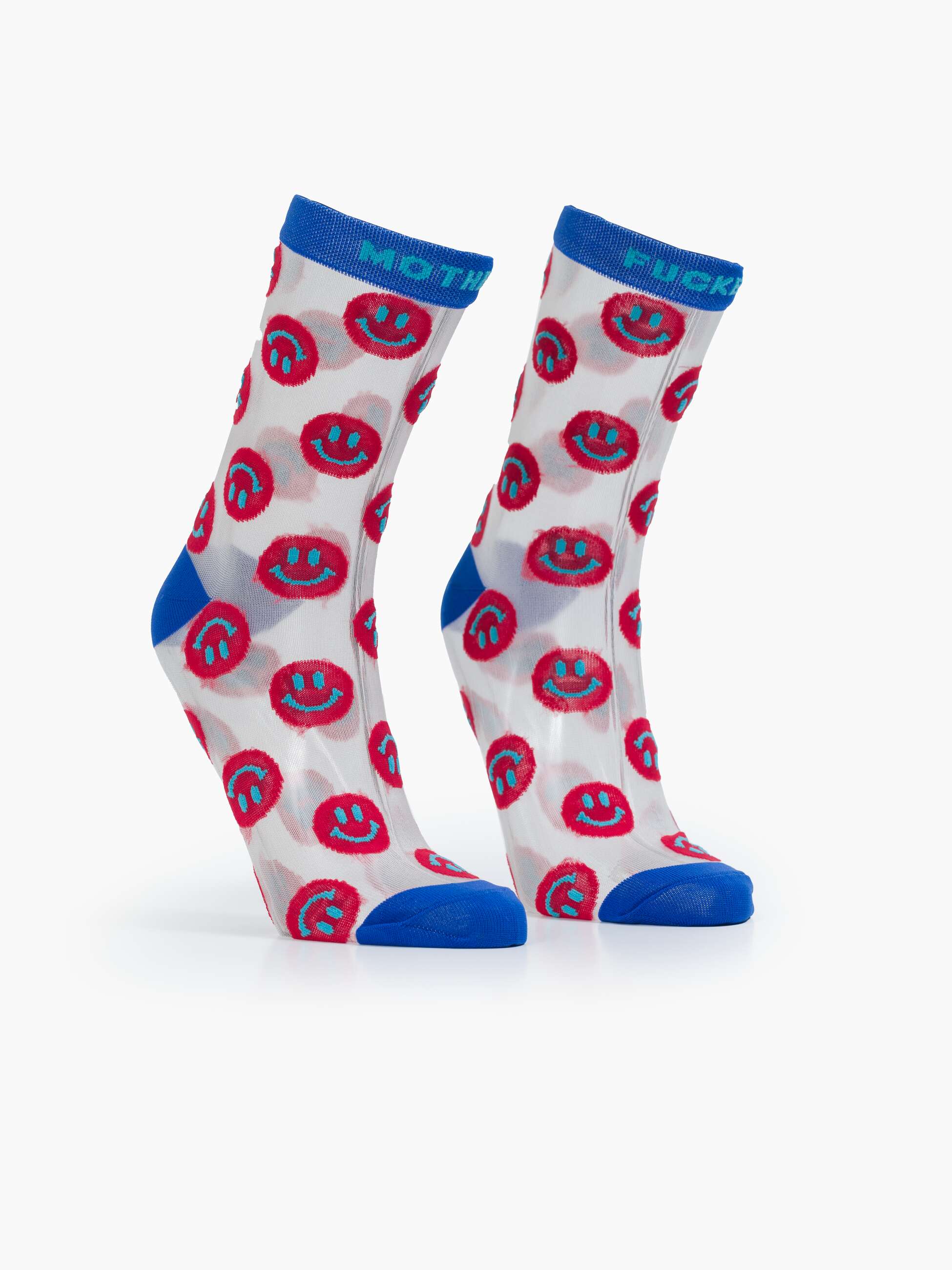 The Step Up Sock by Mother features white tube socks with blue tops, heels, and toes, decorated with red and black smiley faces. One sock reads 'MOTH' while the other says 'SUCKER' in bold blue at the top, accented by black stars.