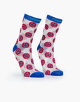 The Step Up Sock by Mother features white tube socks with blue tops, heels, and toes, decorated with red and black smiley faces. One sock reads 'MOTH' while the other says 'SUCKER' in bold blue at the top, accented by black stars.