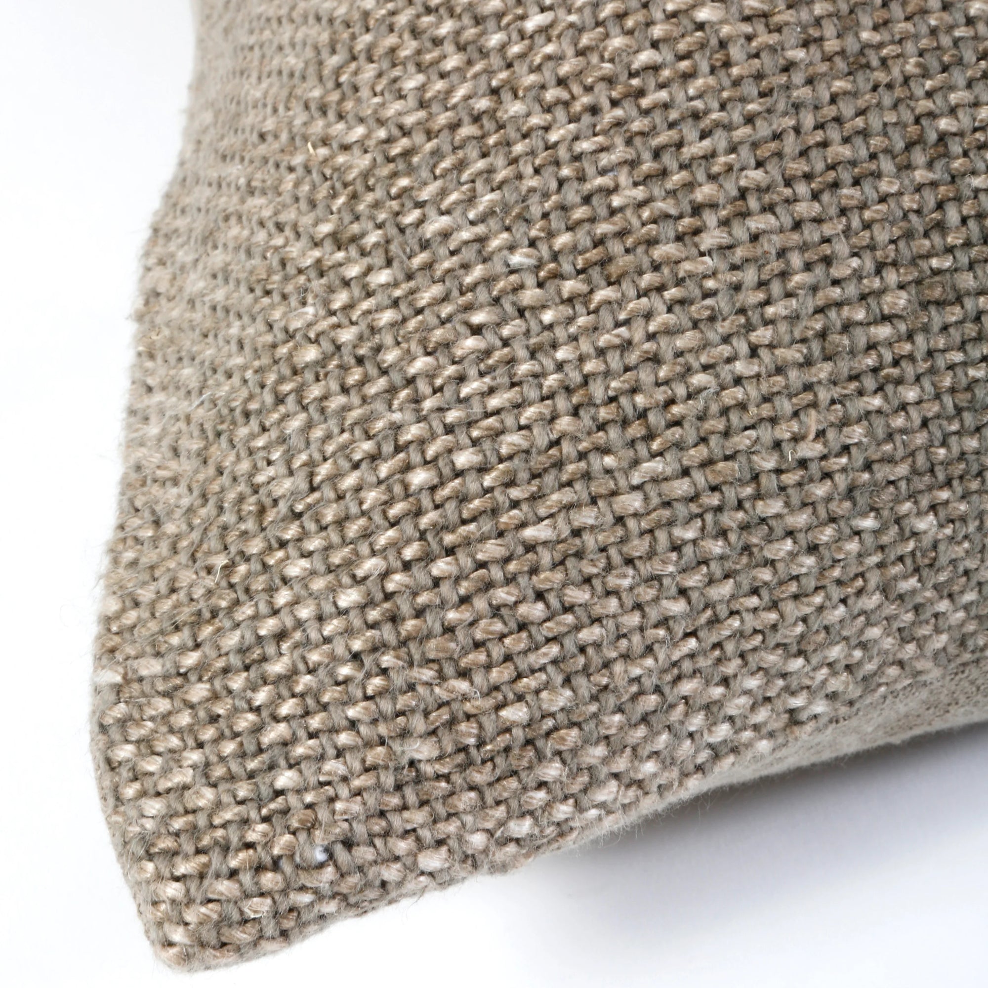 Close-up of the corner of the POM POM Hendrick Body Pillow, featuring a textured beige handwoven cover. The weave pattern stands out against a white background, highlighting its natural fiber look.