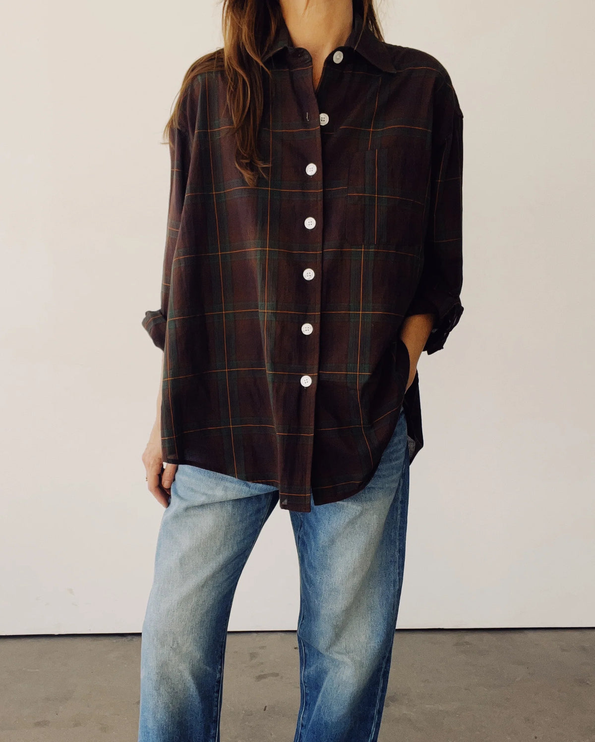 The Big Shirt by Hey Gang in dark plaid cotton poplin with white buttons, paired with faded blue jeans.