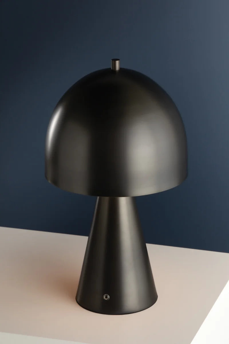 The Hudson Valley Hopkins Rechargeable is a modern, matte black dimmable accent lamp with a dome-shaped mushroom silhouette and conical base, displayed on a white surface against a dark blue background.