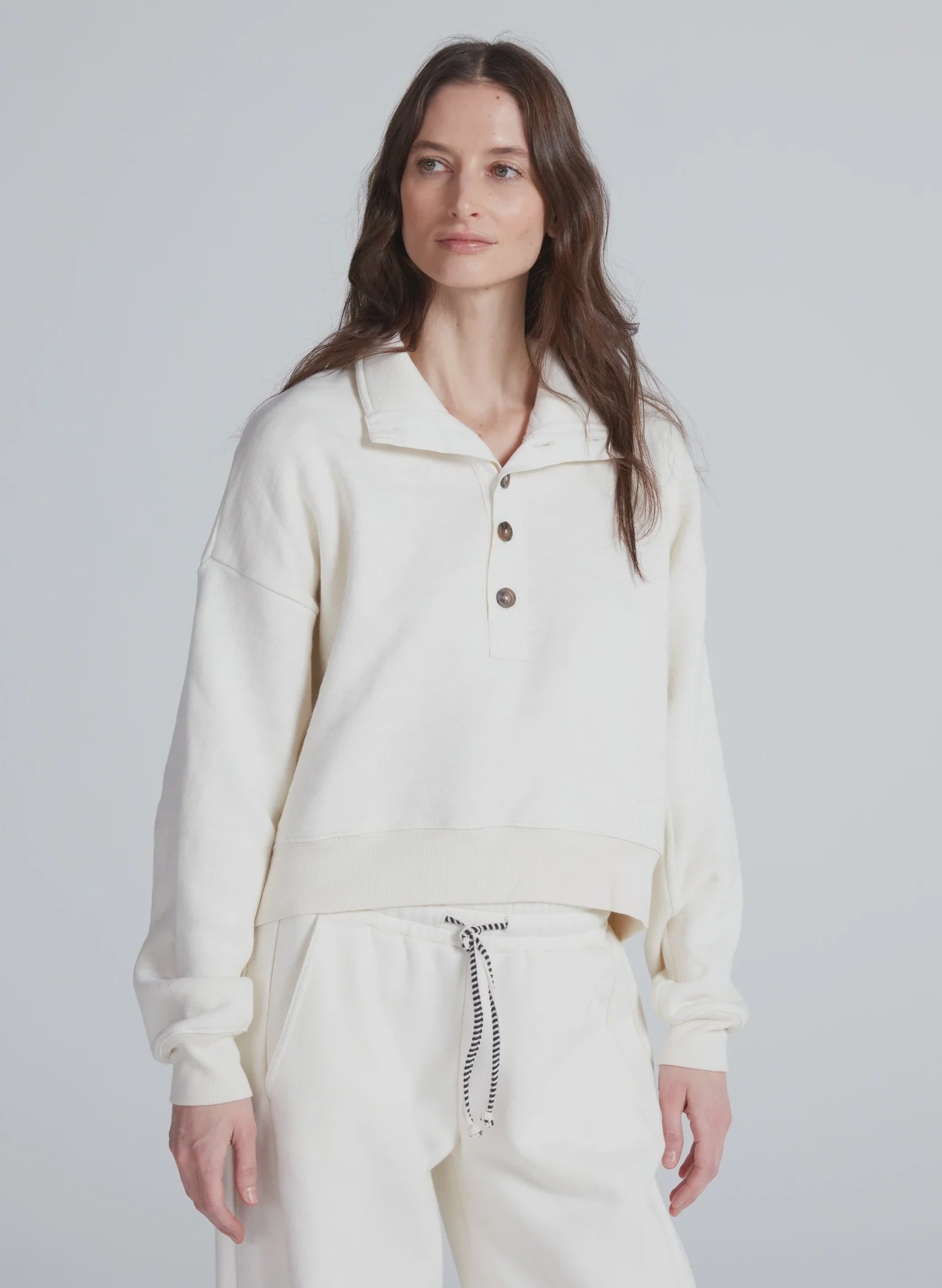 ASKK Leroy Sweatshirt in light gray, relaxed fit, modeled against a plain gray background.