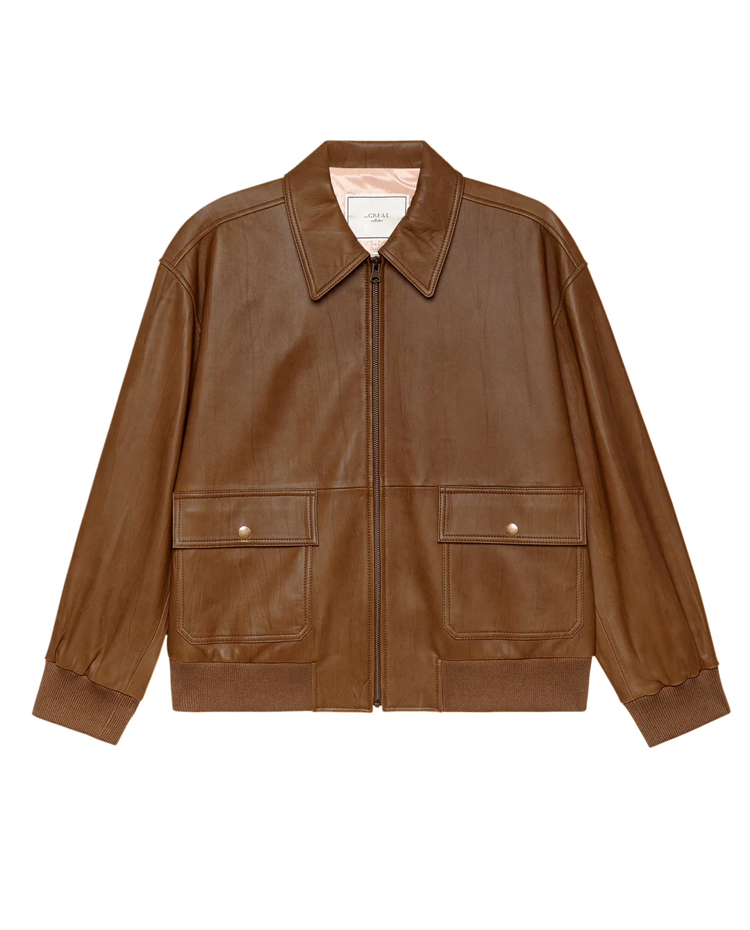 The Great Inc. "The Flight Jacket" is a brown, vintage-inspired lamb leather jacket with a front zipper, two large snap-button flap pockets, a shirt-style collar, and ribbed cuffs and hem, shown on a plain white background.