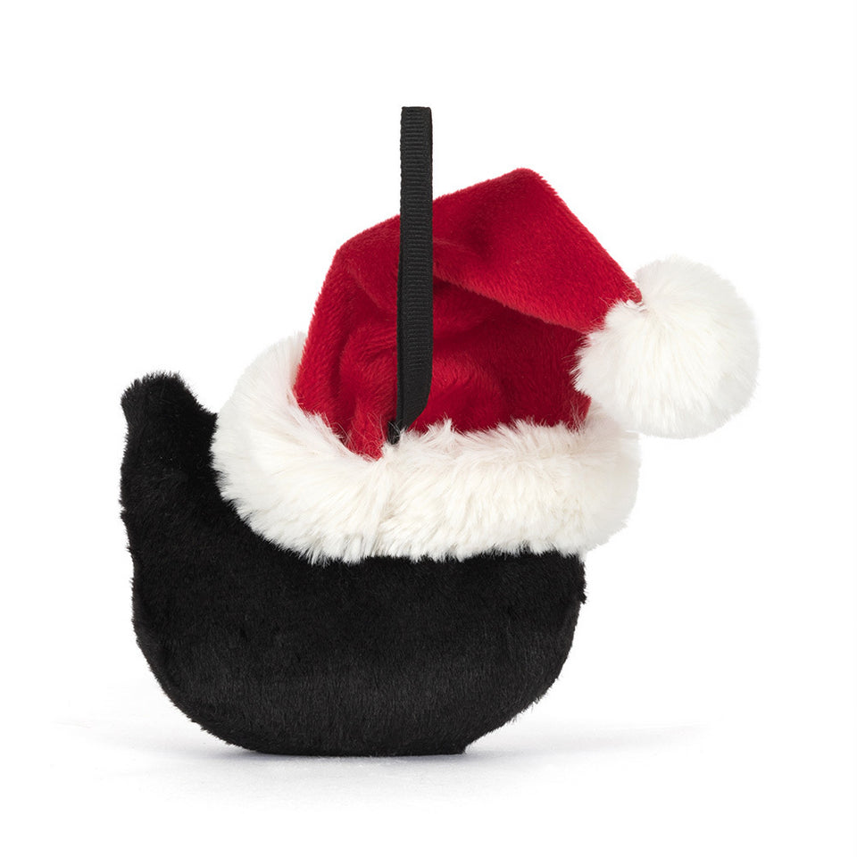 The Jellycat Jack Decoration from Jelly Cat Inc. is a plush black bird ornament with a red and white Santa hat, white pom-pom, and black hanging loop—ideal for festive decor.