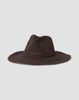 The Sacha Chocolate hat by Janessa Leone is a wide-brimmed, dark brown western fedora with a pinched crown, hand-crocheted from Madagascar straw, shown against a plain light gray background.