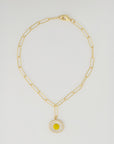 The Perry Custom gold chain necklace by PERRY Styles features elongated links and a daisy-shaped pendant with white petals and a yellow center, making it a unique piece for your personalized stack, shown on a plain light background.