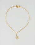 The Perry Custom gold chain necklace by PERRY Styles features elongated links and a daisy-shaped pendant with small gemstones—ideal for unique, personalized stacks or as a standout piece, displayed on a plain white background.