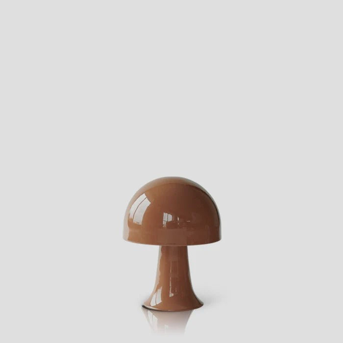 The Julio Portable Table Lamp by Abigail Ahern, in sepia, features a glossy mushroom shape with an integrated LED bulb, set against a plain light gray background.