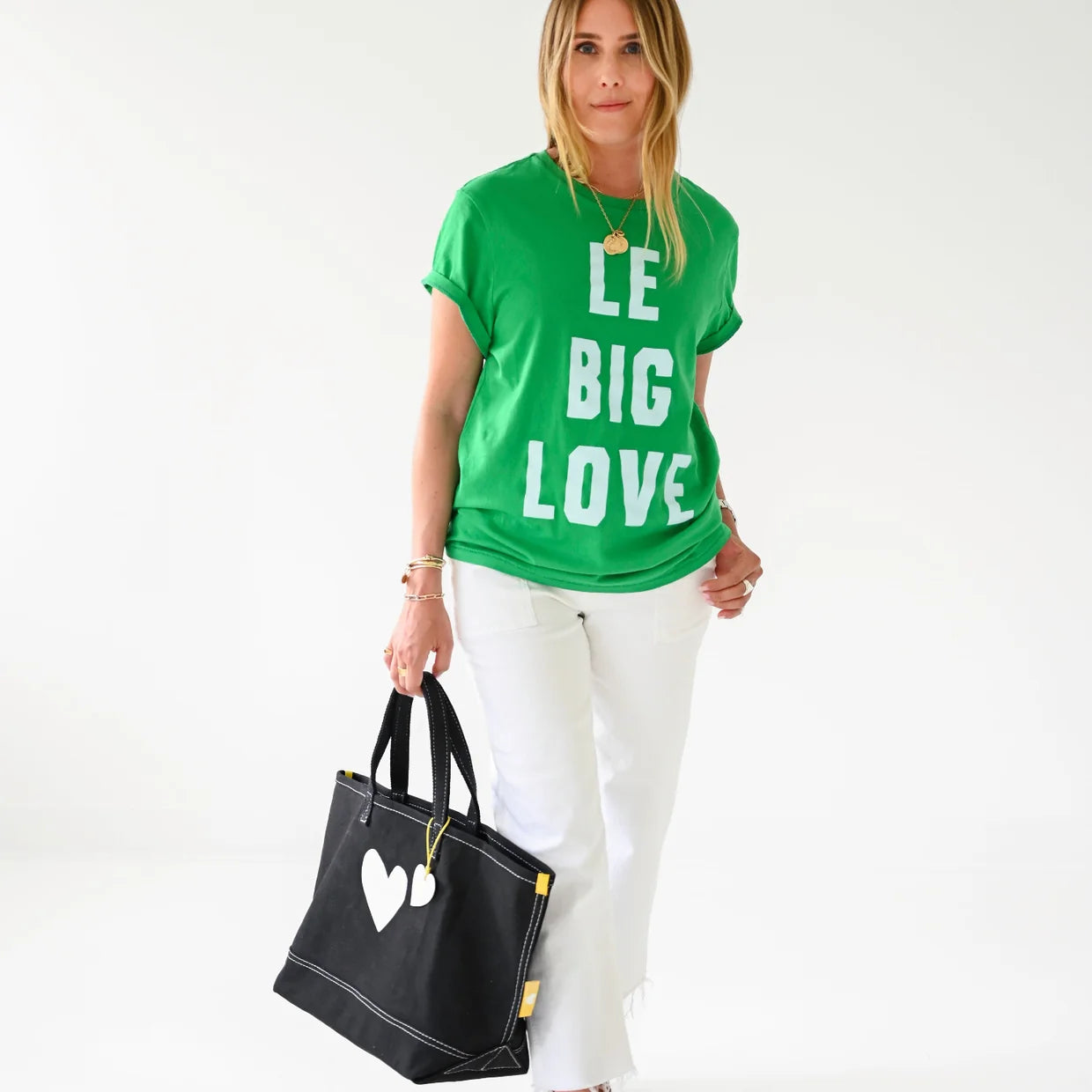 Kerri Rosenthal KR Imperfect Heart Tote with leather charm, styled with green graphic tee and white pants.