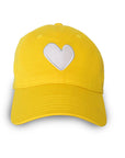 The Kerri Rosenthal KR Imperfect Heart Hat is a bright yellow cap with an embroidered tonal heart patch on the front, shown against a white background.