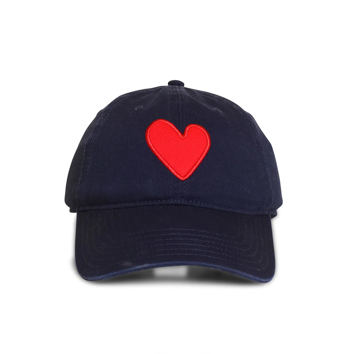 The Embroidered Heart Hat by Kerri Rosenthal is a navy blue baseball cap with a vibrant red heart patch embroidered on the front center.