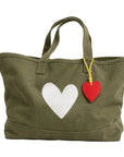 Army green tote with white heart graphic and red leather heart charm, Kerri Rosenthal Imperfect Heart Collection.