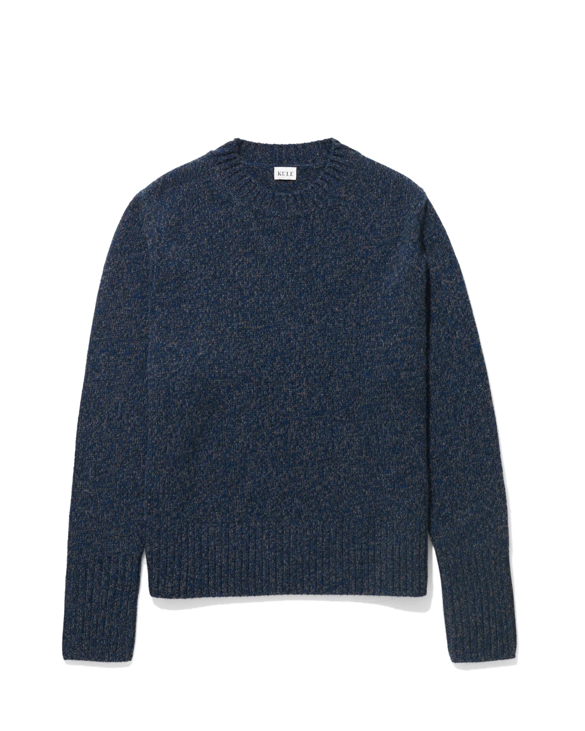 The Cashmere Tatum by Kule, a navy blue cashmere crewneck sweater with long sleeves and extended rib trim at the cuffs and hem, is displayed flat against a white background.
