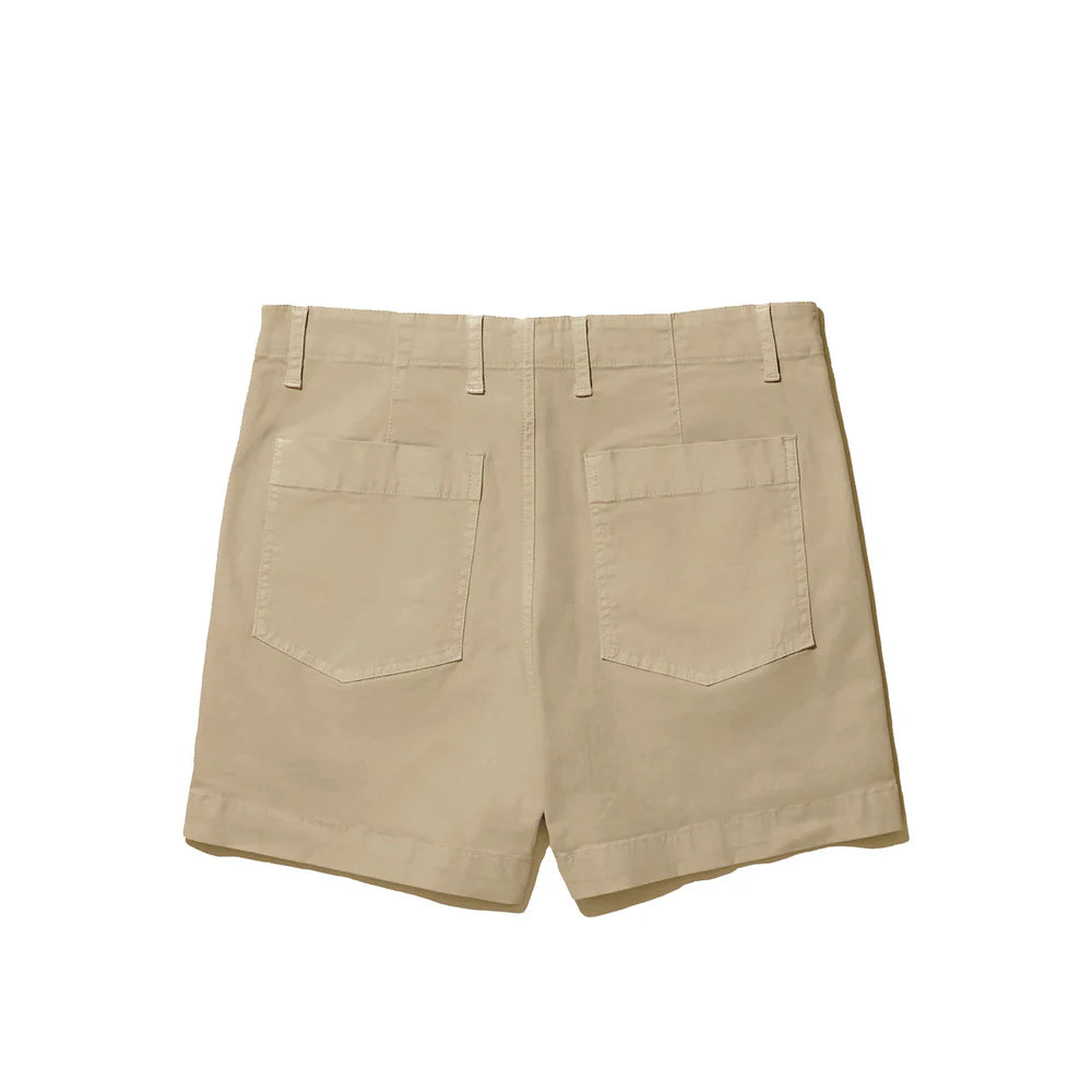 The City Short by Kule is an Italian-made, beige cotton garment featuring a stylish rolled hem, two back pockets, and belt loops. Elegantly photographed against a white backdrop, these shorts provide both comfort and style.