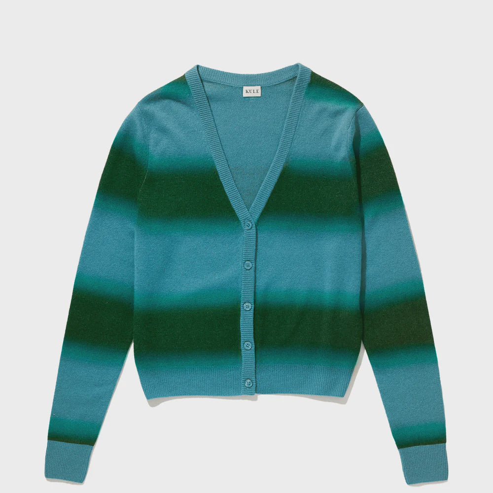 The Millie cardigan by Kule, a V-neck striped cashmere piece in shades of teal and dark green with a five-button closure on the front, is laid flat on a white background.