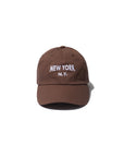 A brown Kule New York Kap featuring "NEW YORK N.Y." embroidered in white on the front, shown against a plain white background.