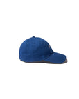 A blue Kule "The New York Kap" is displayed from the side on a white background, featuring a slightly curved brim and visible stitching.