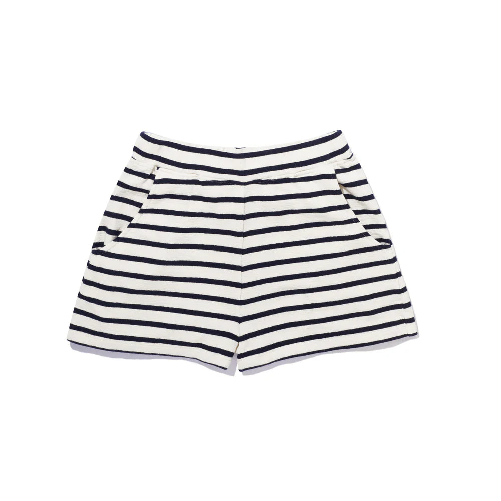 The Eco Cotton Venus shorts by Kule are white pull-on shorts made from organic cotton, with horizontal black stripes and side pockets.