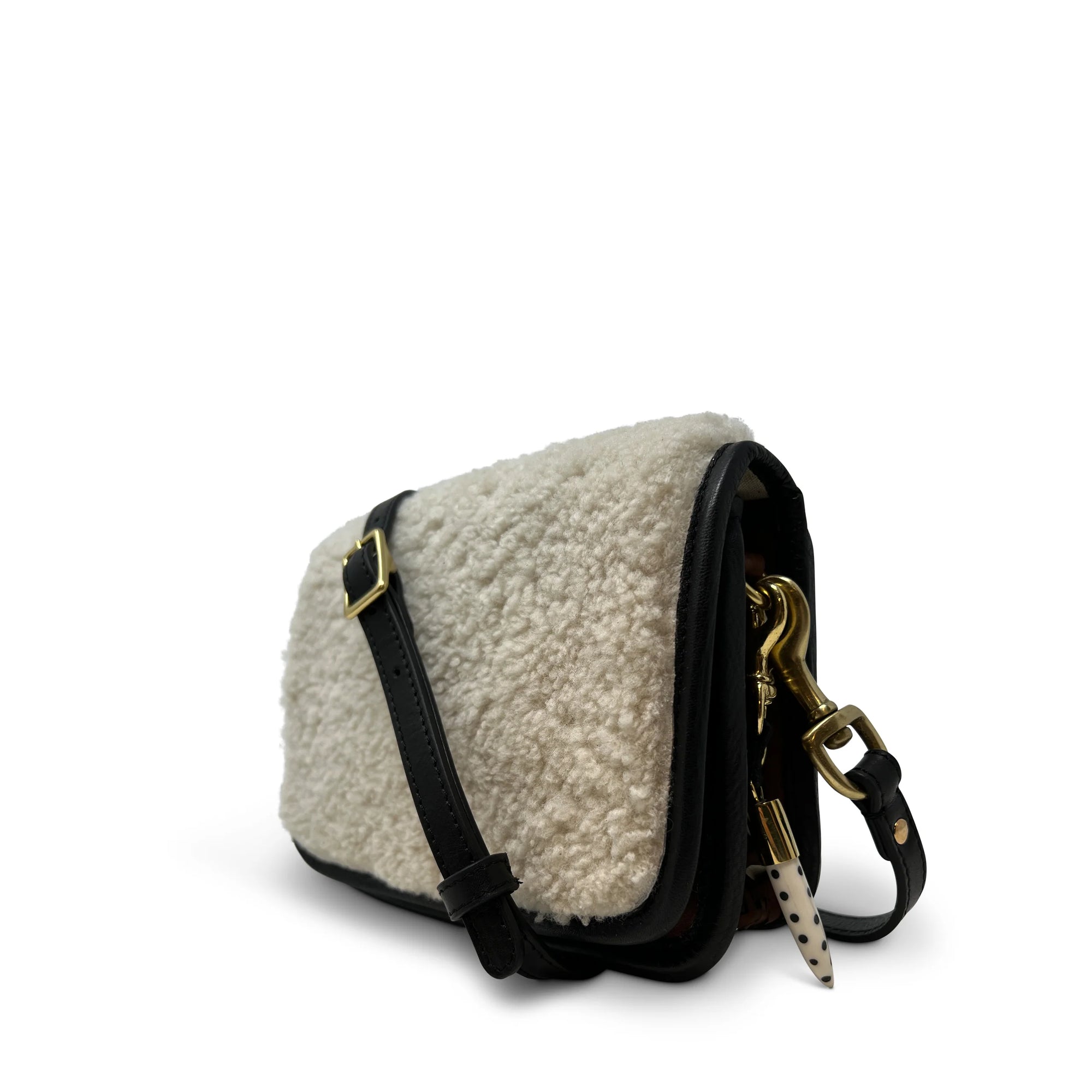 The Kempton & Co. Mini Mia Crossbody features a soft, textured white shearling exterior, black leather strap and trim, and gold hardware, all shown against a plain white background.