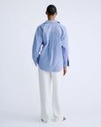 HILLARY striped cotton shirt in white by Love Stories, styled with white pants against a plain backdrop.