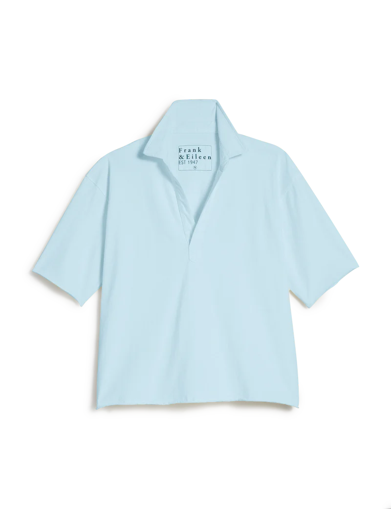 The Patty Popover SS Henley by Frank &amp; Eileen is a light blue short-sleeved top with a relaxed fit and open V-neck, shown flat on a white background. The inner label reads "Frank &amp; Eileen EST 1947.