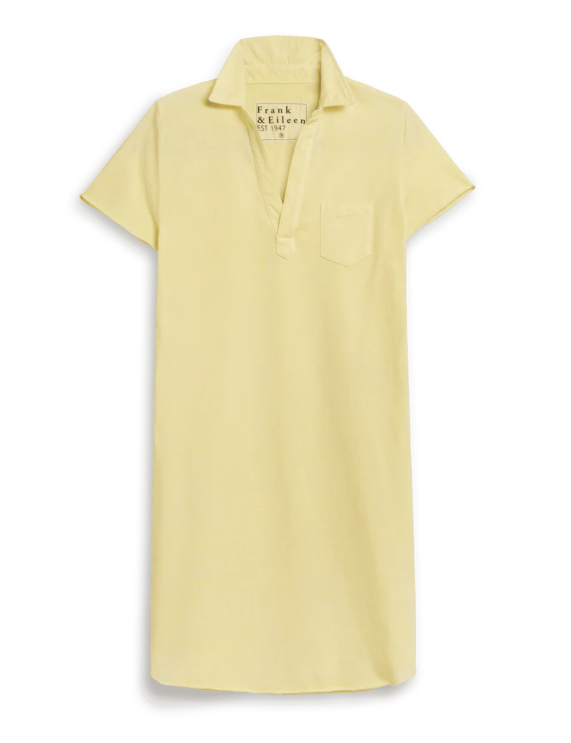 The Lauren Polo Dress by Frank & Eileen is a mini, short-sleeve light yellow dress with a collar, chest pocket, and V-neck opening, offering a preppy classic style.