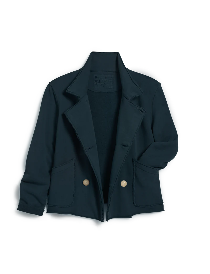 The Frank & Eileen MINI BELFAST Crop Peacoat, a single-breasted dark navy blazer with gold buttons, two front patch pockets, and raw edges, evokes classic English peacoat style and is displayed flat against a white background.