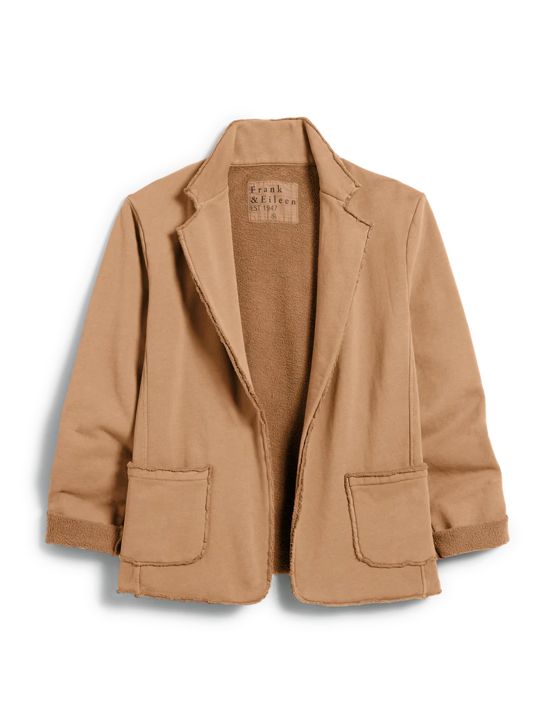 The Dublin Knit Blazer by Frank & Eileen is a light brown, 100% cotton everyday blazer featuring raw edges, two front pockets, rolled sleeves, and a relaxed fit.