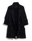 The Frank & Eileen Sweatshirt Trench Coat is a long black, double-breasted English-style coat with notched lapels, large patch pockets, rolled-up sleeves, and is machine-washable. Shown against a plain white background.