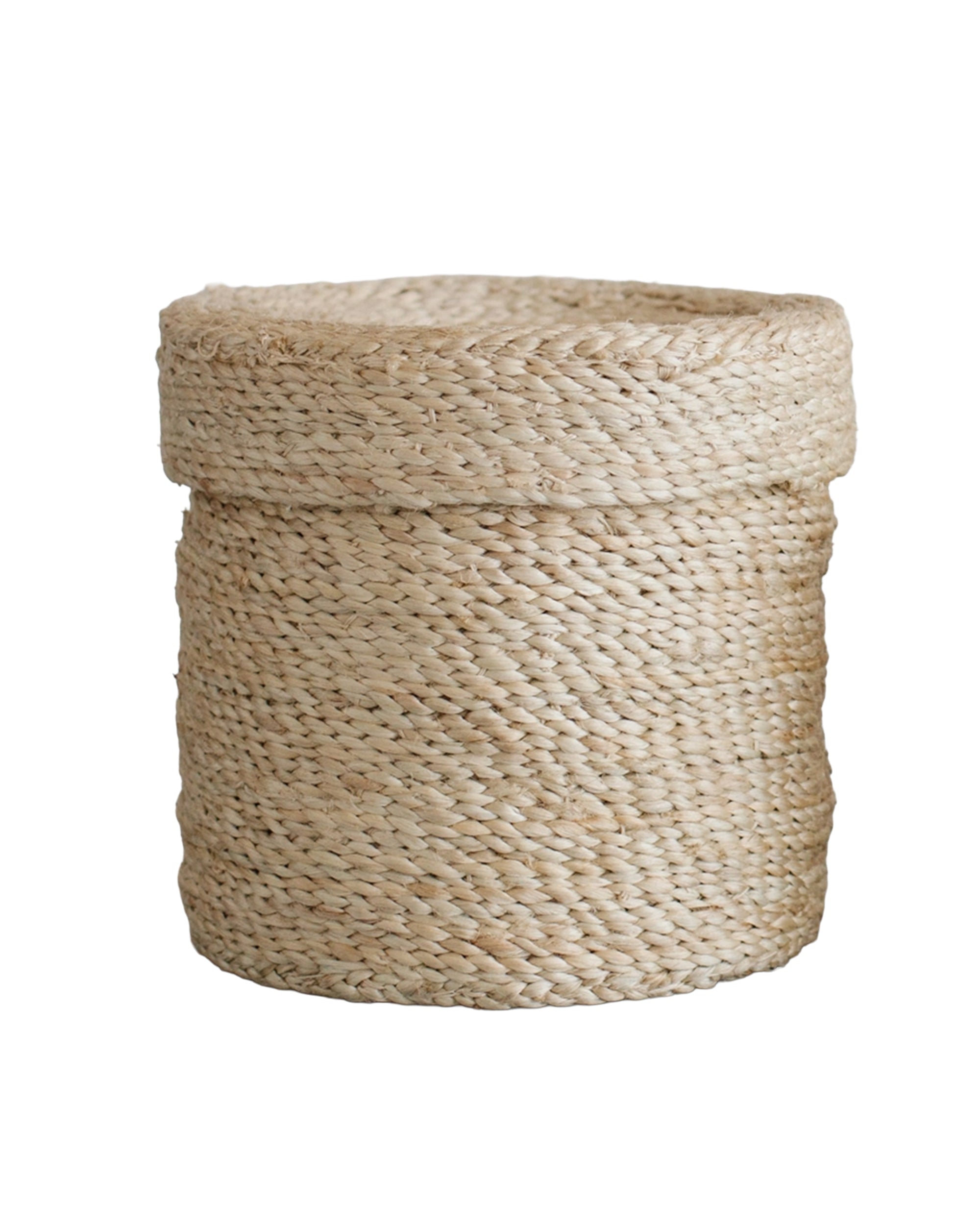 The Faire Round Lidded Jute Basket features a thick-rimmed, handwoven design from natural fibers and a slightly uneven texture, shown against a white background.
