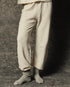 The Great Inc. Dance Pant in gray with matching socks, waist-down view against a textured gray background.