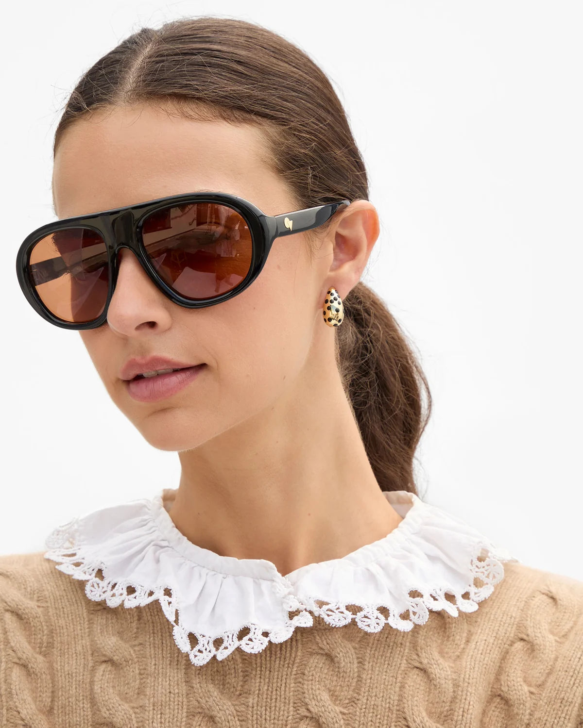 Clare Vivier Le Drop Earrings worn with a tan sweater and lace collar for a chic, modern look.