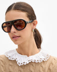 Clare Vivier Le Drop Earrings worn with a tan sweater and lace collar for a chic, modern look.