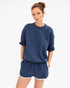 Navy Clare Vivier Le Jogging Shorts with elastic waistband and side pockets, styled with a blue sweatshirt.