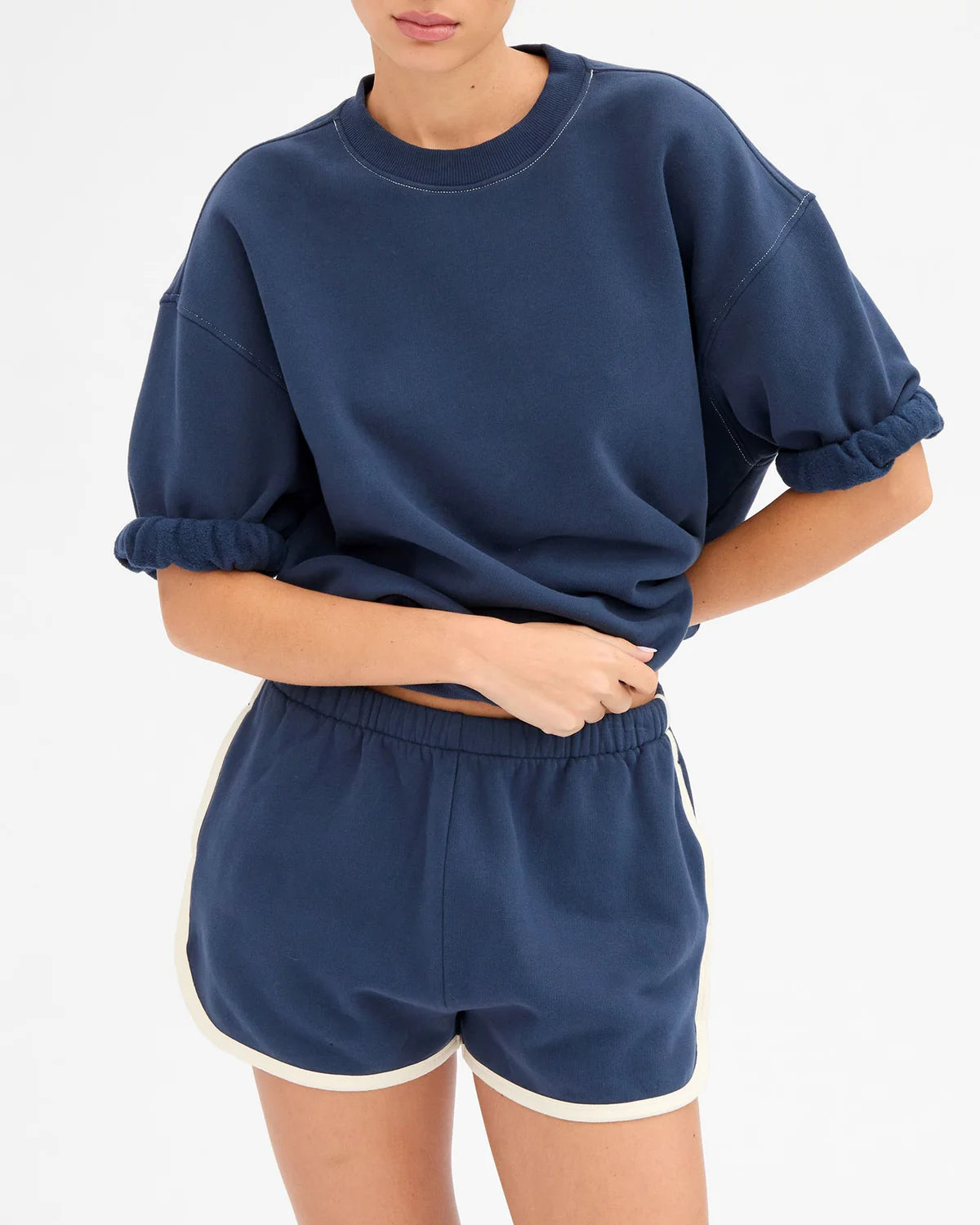 Navy cotton Le Jogging Short with elastic waist and side pockets by Clare Vivier, styled with a matching top.