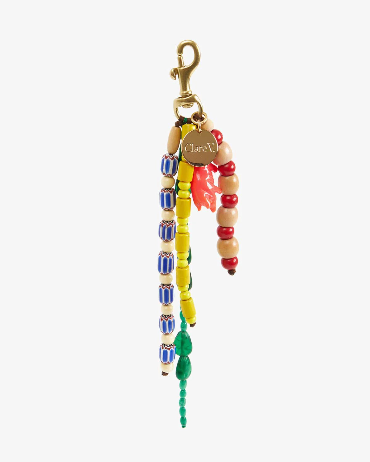 The Clare Vivier Le Long Beaded Tassel is a colorful keychain with strands of blue, yellow, red, wood, and green beads, a small red animal charm, and a vintage gold-plated clip with a circular gold tag.