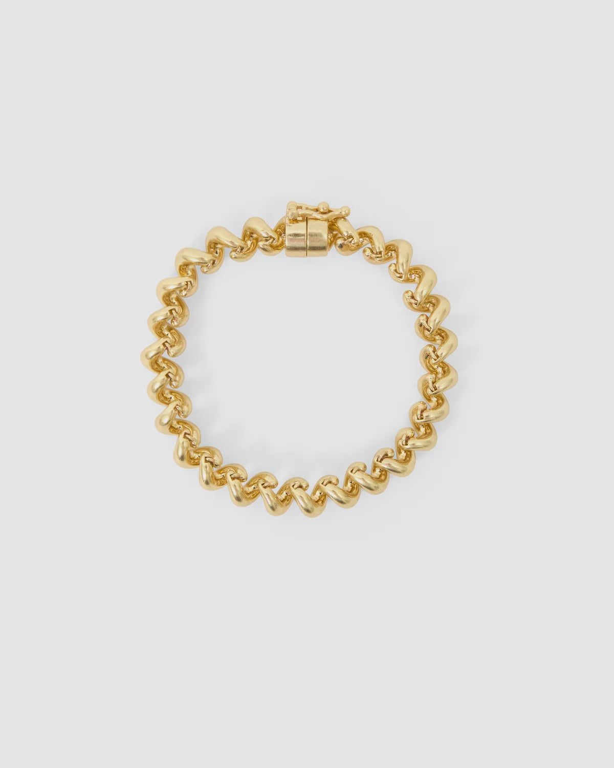 Gold-plated chain-link bracelet with magnetic clasp by Clare Vivier, shown against a white background.