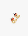 Gold-plated brass lips stud earrings with black and red enamel stripes by Clare Vivier on a white background.