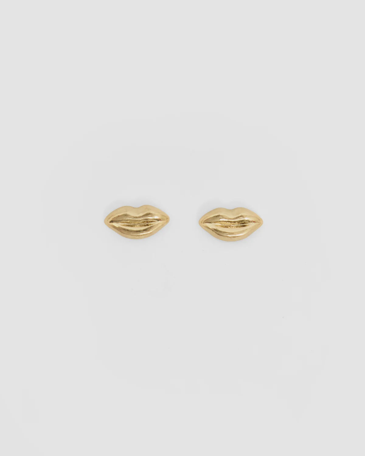 Gold-plated brass lips stud earrings with enamel stripe by Clare Vivier, shown on a white background.