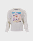 The I'm That Cowgirl LS Tee by Hunter Bell NYC features a fun goat graphic with gear before a mountain and "I'm that Guapito!" printed below, perfect for adventurous cowgirls.