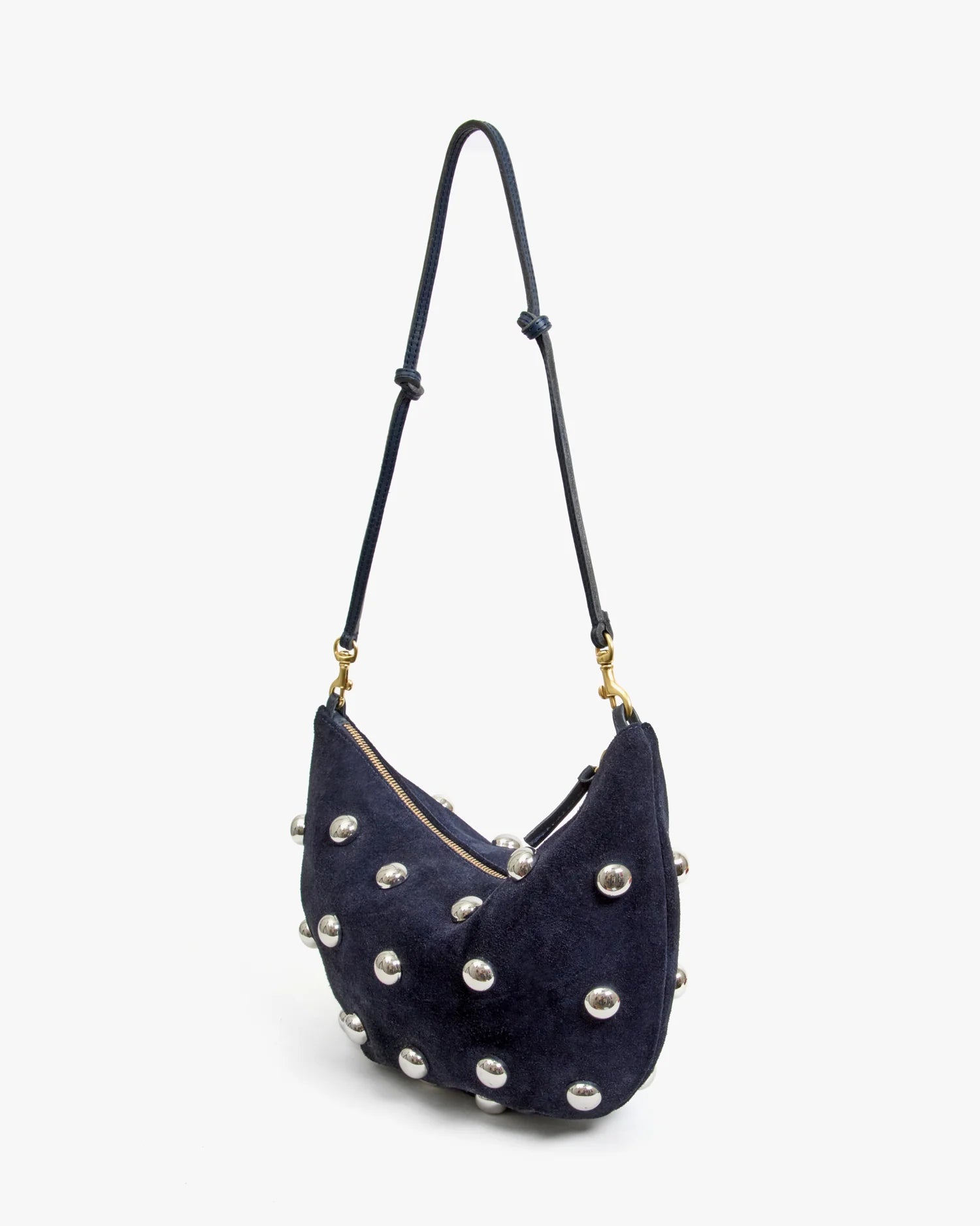 The Clare Vivier F25-Lune is a small dark blue shoulder bag featuring a long adjustable strap, secure zipper closure, and multiple large silver studs. It stands upright against a plain white background.