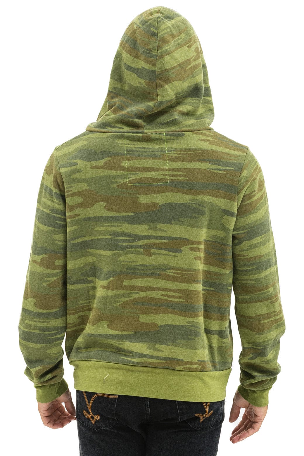 Person seen from behind wearing the Aviator Nation 5 stripe - zip hoodie in green camo with solid green hem and cuffs for a vintage look, hood up, paired with dark jeans.