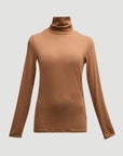 The Majestic Filatures Soft Touch L/S Turtleneck is a plain, light brown long sleeve shirt with a soft touch, shown against a white background.